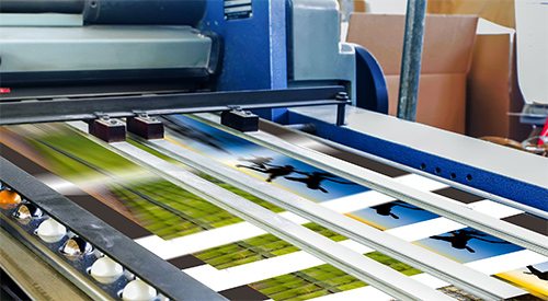 A close-up of a high-speed digital printing press in operation, illustrating printing capabilities.